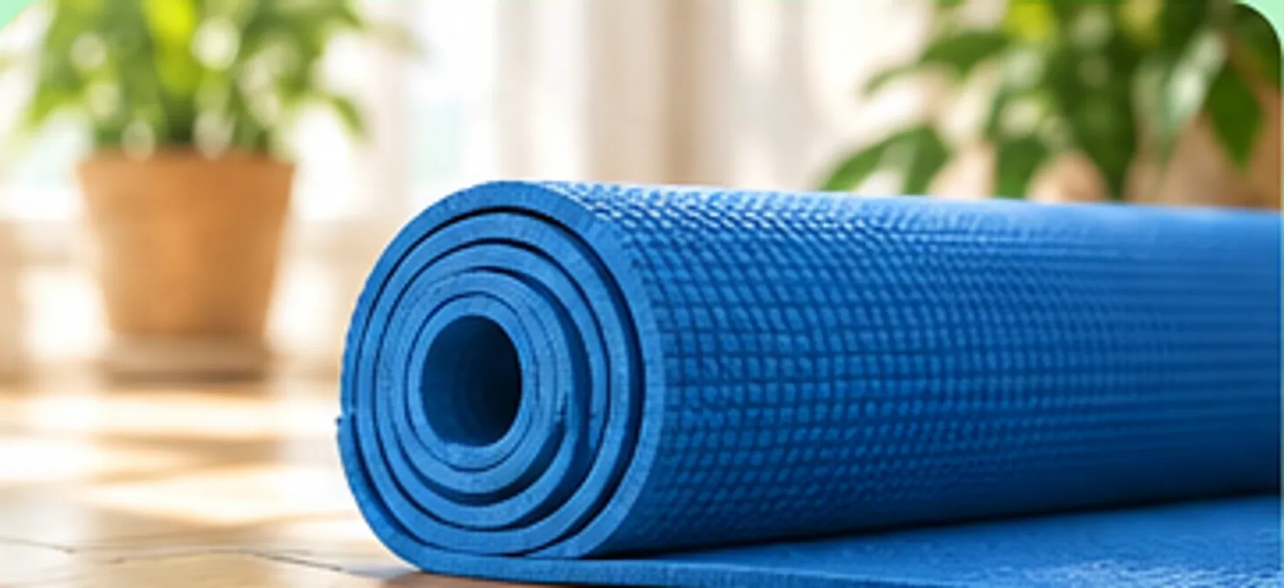 Opgerolde blauwe yogamat op een houten vloer naast groene planten